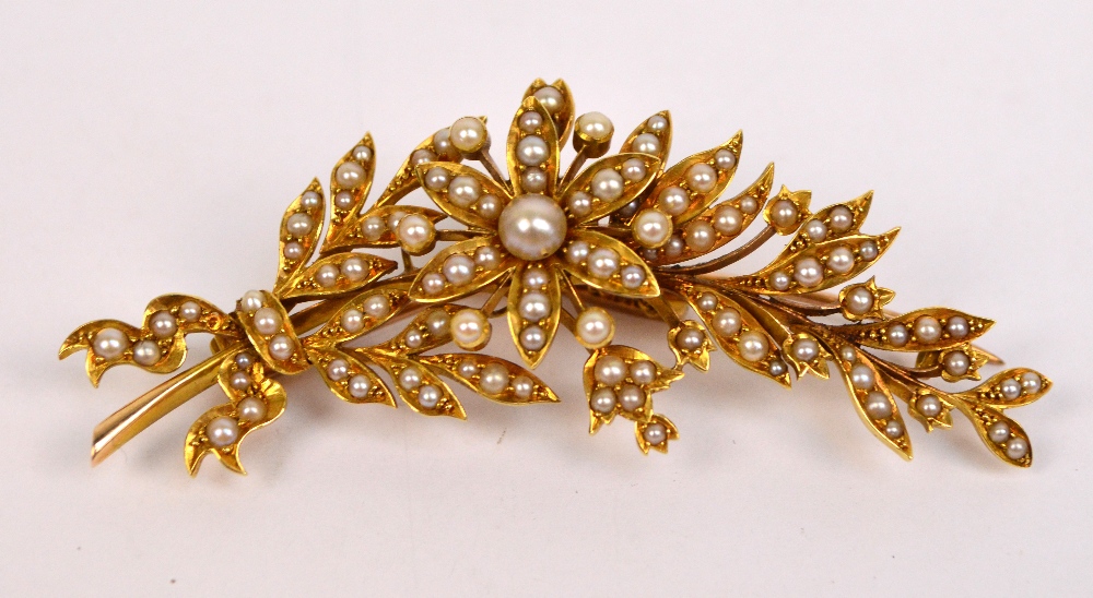 An Edwardian yellow metal and seed cultured pearl floral bar brooch,