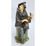 A reproduction decorative Art Deco style figure of a seated Pierrot, height 31cm.