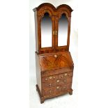 A George I style walnut and feather banded double domed bureau bookcase of small proportions,
