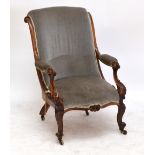 A Victorian mahogany framed scroll back elbow chair with floral carved detail to the arms and