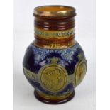 A Doulton Lambeth stoneware jug commemorating Queen Victoria's Diamond Jubilee in 1897,