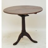 A George III mahogany tripod tilt top table with bird cage action above turned column and outswept