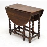 An oak gateleg drop leaf dining table raised on turned and block supports, the base 18th century,