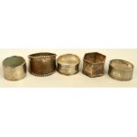 A small collection of hallmarked silver napkin rings including a floral bright cut example with