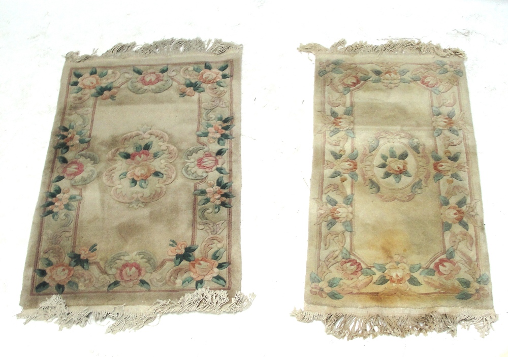 Two similar beige floral decorated carpets, 132 x 77cm and 129 x 62cm (2). - Image 2 of 2