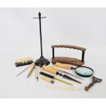 A seven section curved pen display stand, a magnifying glass and matching paper knife,