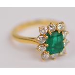 BOODLE & DUNTHORNE; an 18ct yellow gold emerald and diamond ring,