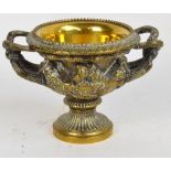 A late 19th century brass model of the Warwick vase with removable liner and spreading circular