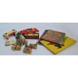 A vintage Chinese clockwork tin bike toy, a similar French car with a driver, and a tin milk wagon,