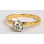 A yellow gold brilliant cut diamond solitaire ring, the stone in high platinum setting approx 0.