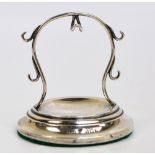 A George V hallmarked silver balloon shaped lady's fob watch/ring stand on spreading circular