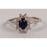 An 18ct white gold sapphire and diamond floral set ring, size L, approx 2.7g.