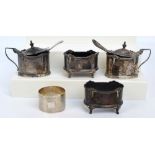 A George IV hallmarked silver four piece cruet set comprising two oval open circular salts with