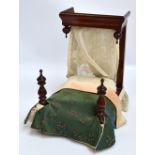 A Victorian mahogany half tester doll's bedstead with turned finials,