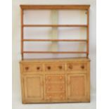 A Victorian pine Welsh dresser base with three frieze drawers above three simulated drawers acting