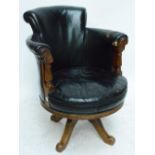 A Victorian mahogany framed revolving upholstered circular tub chair on four scallop decorated