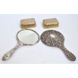 A cased pair of Elizabeth II hallmarked silver backed Art Deco style brushes of rectangular forms