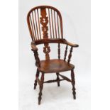 A 19th century ash and elm high hoop back Windsor type elbow chair with saddle seat an straihgt