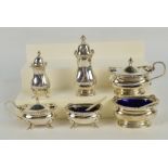 A George V hallmarked silver three piece cruet set,