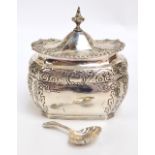 A Victorian hallmarked silver tea caddy of shaped octagonal form with domed hinged lid surmounted