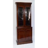 An Edwardian mahogany bookcase of rounded rectangular form,