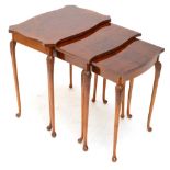 A nest of three walnut occasional tables of shaped rectangular form with four leaf capped cabriole