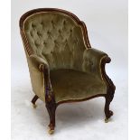 A Victorian walnut framed button upholstered armchair with serpentine front rail and knee carved