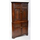 A large Georgian early 19th century carved oak corner cabinet.
