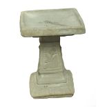 A modern concrete square section bird bath.