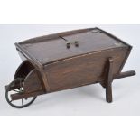 A early 20th century sewing box modelled as a wheelbarrow,