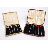 A cased set of six George V hallmarked silver cocktail sticks with red bakelite cherry shaped