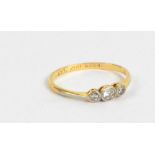 An 18ct yellow gold and tiny diamond three stone ring, size N, approx 1.5g.