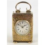 An Edwardian VII hallmarked silver cased small carriage clock with hammered finish and looped