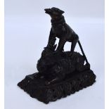 An 18th/19th century Hindu bronze figure group of a stylised dog upon the back of an elephant on a