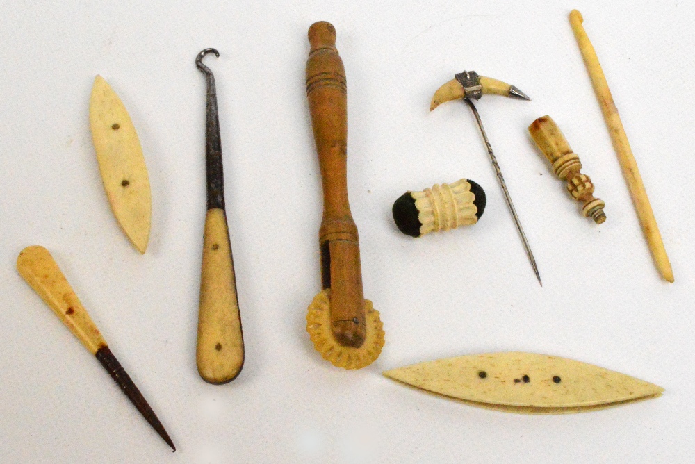 A small group of bone sewing tools including a crochet hook, a piercer, a pin cushion etc,