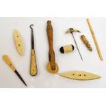 A small group of bone sewing tools including a crochet hook, a piercer, a pin cushion etc,