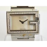 GUCCI; a modern lady's wristwatch, the dial framed by the Gucci letter G and set with diamonds, no.