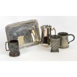 A Liberty & Co Tudric pewter mug with scrolling loop handle, the base stamped "Made in England,