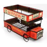 A 1950s tin plate "Guinness Omnibus" advertising shop display stand modelled as a double decker bus,