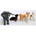 Four figures of Beswick animals; "Terrier - walking", no. 1062, "Dachshund - seated", no.