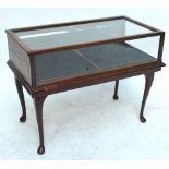 A reproduction low bijouterie table, the glazed top 79 x 41cm.