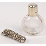 A Victorian hallmarked silver topped and clear glass scent bottle of flat circular form,