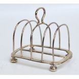 A George V hallmarked silver four division toast rack of simple hooped form, London 1923, length 9.