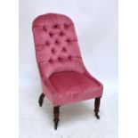 A Victorian rosewood framed button upholstered nursing chair raised on fluted tapering front legs