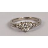 A platinum and diamond ring, the principal stone weighing approx 0.