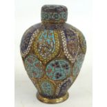 An Eastern brass and enamel floral decorated tea caddy of baluster form with incised body with