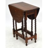 A small early 20th century oak drop leaf gateleg table raised on barleytwist supports.