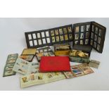 A quantity of cigarette cards, both loose and in albums, also several in vintage tins.