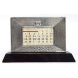 A George V Silver Jubilee hallmarked silver fronted perpetual ebonised desk calendar of rectangular