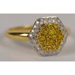 A 9ct yellow gold diamond and fancy yellow diamond ring with hexagonal raised central platform,